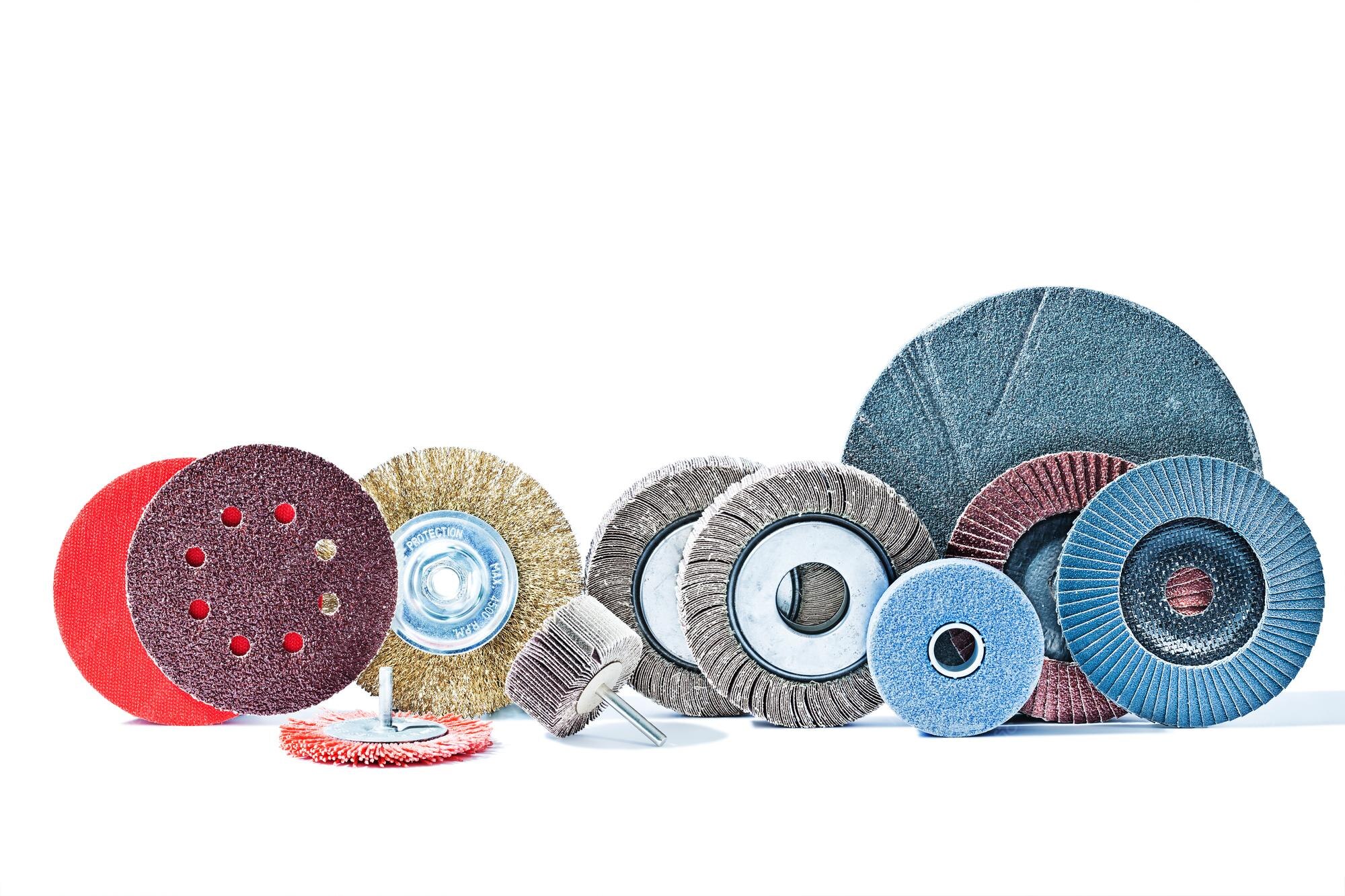 Macro photography of industrial buffing wheels and polishing compounds with soft diffused lighting.